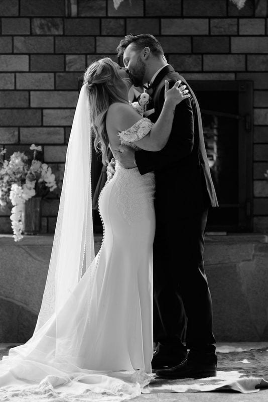 The kiss in front of the stone fireplace