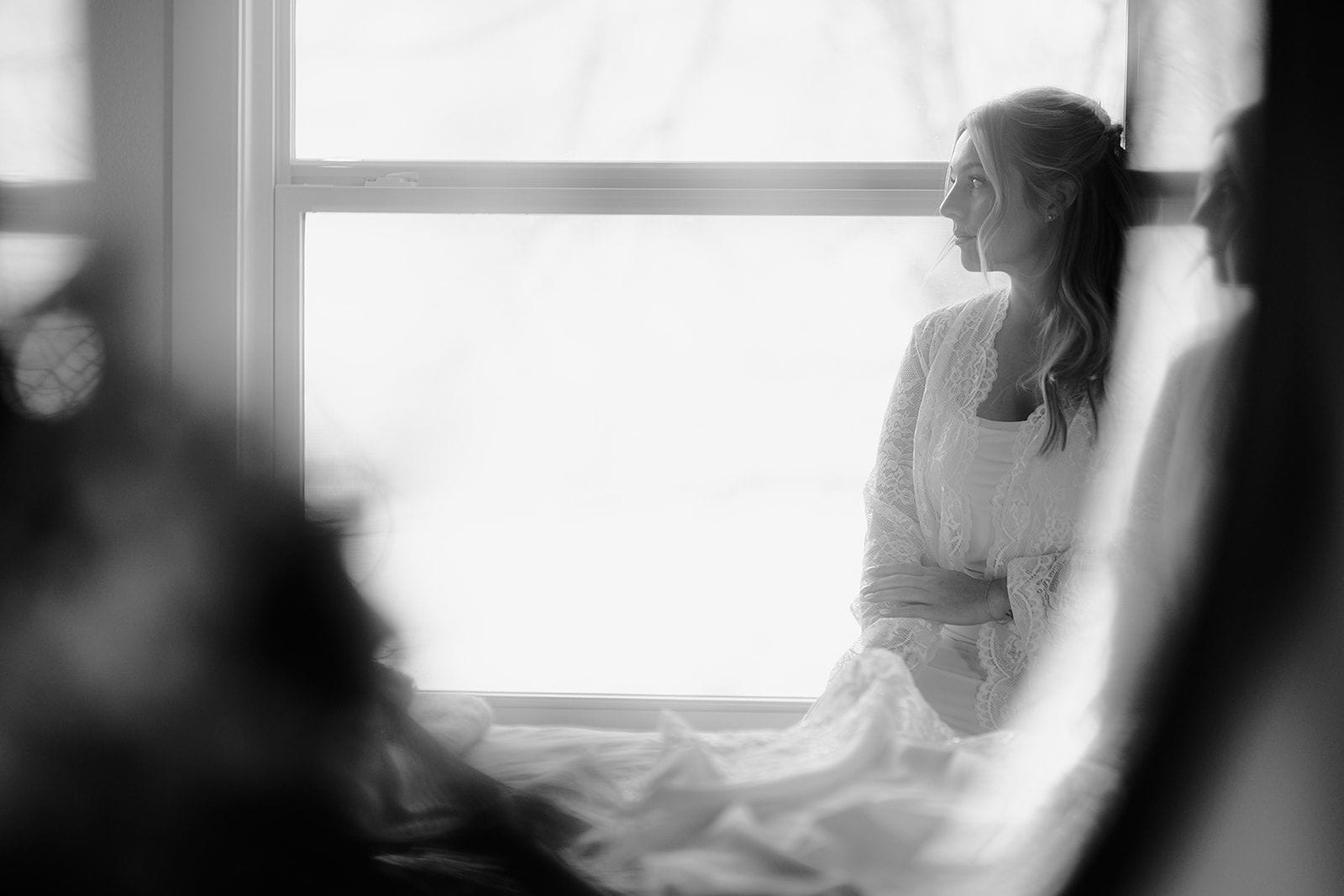 Carlee sitting by the window before she gets dressed