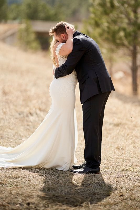 Carlee and Tayven holding each other after the first look, in the pines