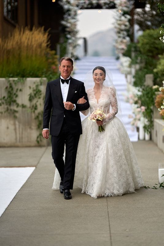 Noelle walking down the aisle on her father's arm