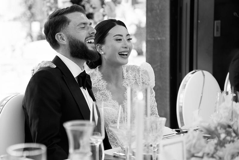 Noelle and Richie laughing at the head table during the toasts