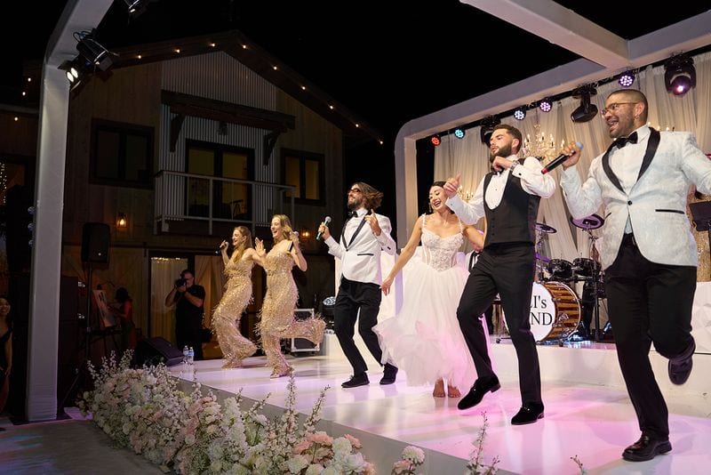 Richie and the groomsmen dancing on the stage after dark