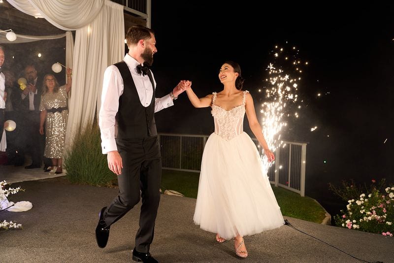 Noelle and Richie running out between the sparklers