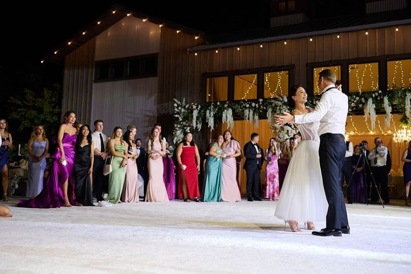 The first dance under the string lights, the guests in a ring