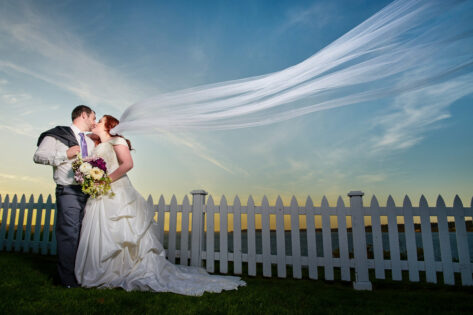 bride and groom kissing with veil in the wind, port gamble weddings