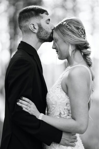 groom kissing bride on forehead, photographed for Complete Weddings & Events, black hills receptions wedding, photographer near me, black hills wedding, fall wedding