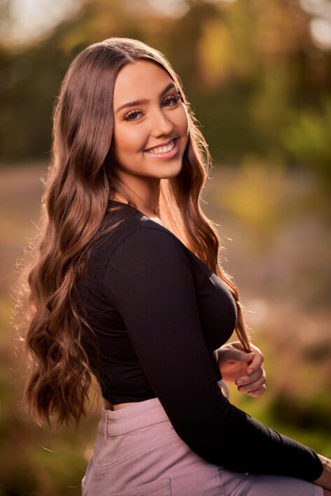 Senior girl with long hair smiling at the camera, rapid city senior photographer