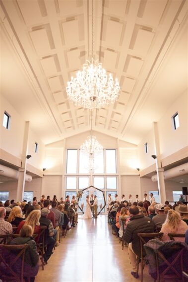 indoor wedding ceremony, winter wedding, photographed for Complete Weddings & Events, black hills barn wedding, barn at aspen acres wedding, spearfish wedding
