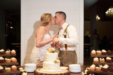 bride and groom cake cutting, winter wedding, photographed for Complete Weddings & Events, black hills barn wedding, barn at aspen acres wedding, spearfish wedding