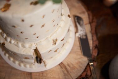cake with slice cut out, winter wedding, photographed for Complete Weddings & Events, black hills barn wedding, barn at aspen acres wedding, spearfish wedding