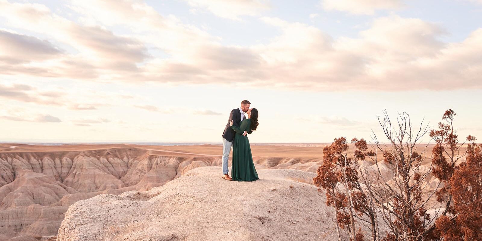 couple kissing on edge of cliff, badlands of south dakota, badlands engagement photographer