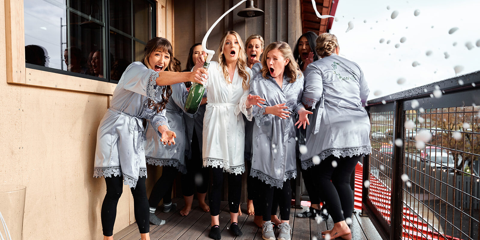 bridesmaids popping champagne, farm 12 puyallup wedding