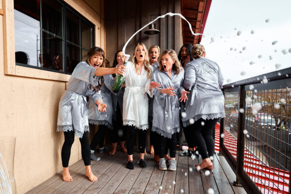 bridesmaids popping champagne, farm 12 puyallup wedding