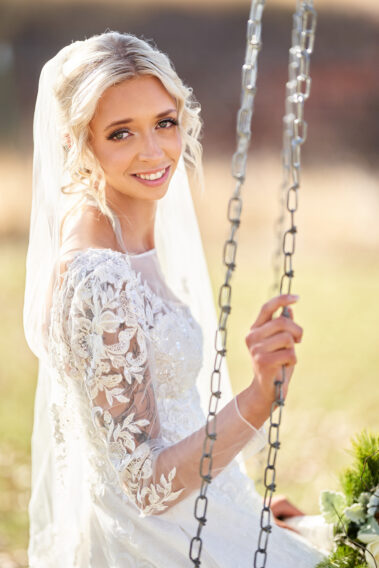 bride sitting on a swing