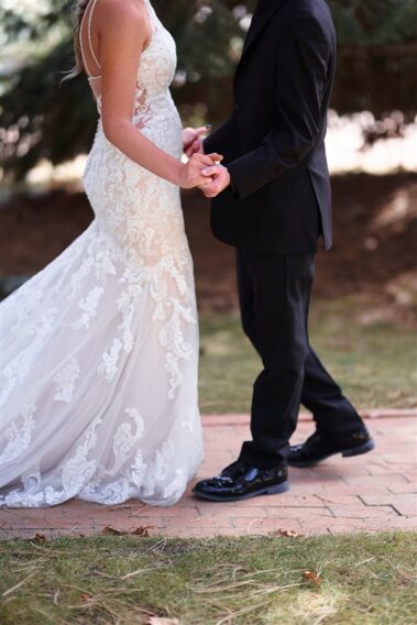 bride and groom holding hands at black hills receptions wedding