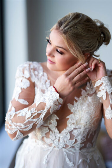 bride putting on earring barn at aspen acres wedding black hills barn