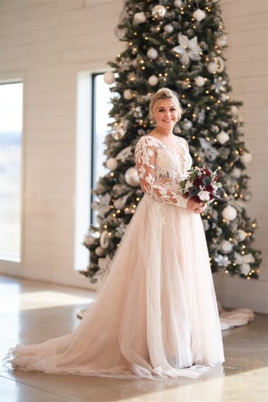 bridal portrait in front of christmas tree barn at aspen acres wedding black hills barn