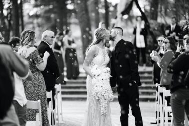 bride and groom kiss down the aisle at black hills receptions wedding