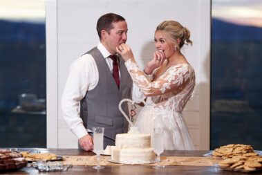 bride and groom cut cake barn at aspen acres wedding black hills barn