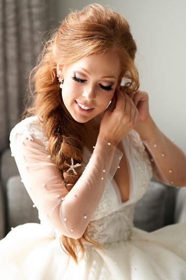 bride putting on her earrings