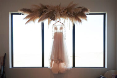 wedding dress hanging at barn at aspen acres wedding black hills barn