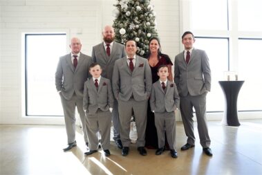 wedding party in front of christmas tree barn at aspen acres wedding black hills barn