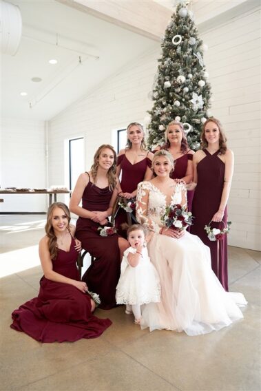 wedding party in front of christmas tree barn at aspen acres wedding black hills barn